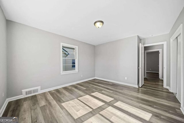 unfurnished room with dark hardwood / wood-style floors