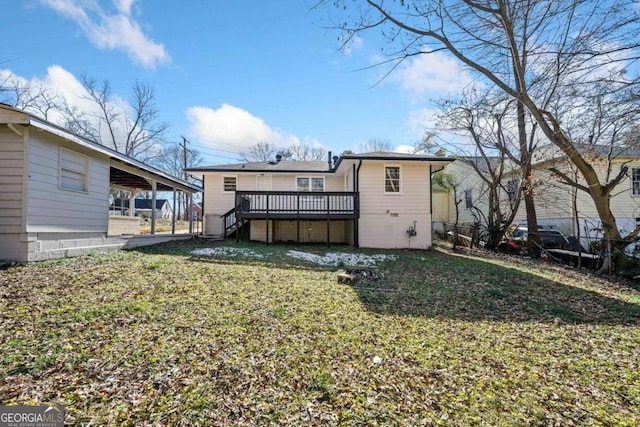 rear view of house with a yard and a deck