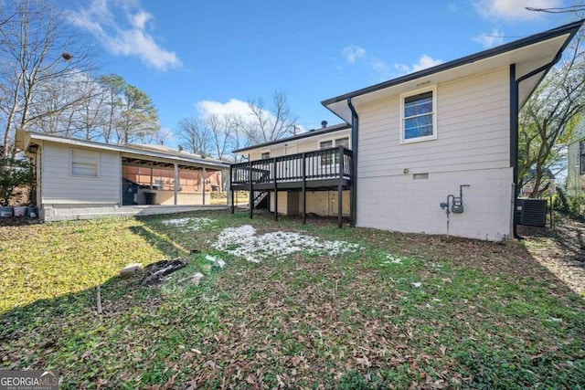 back of house featuring a deck, central AC unit, and a lawn