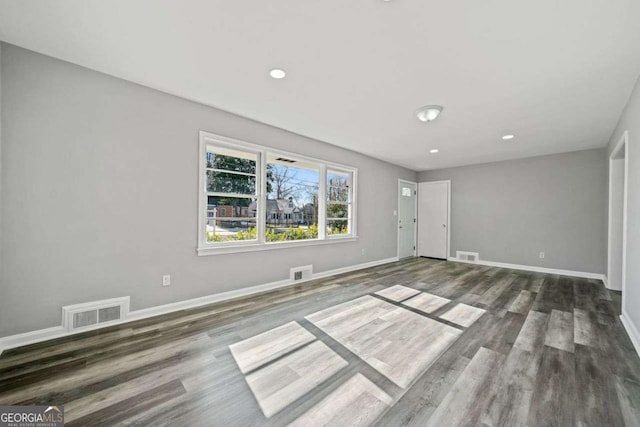 spare room featuring dark hardwood / wood-style floors