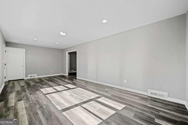 spare room with dark hardwood / wood-style flooring