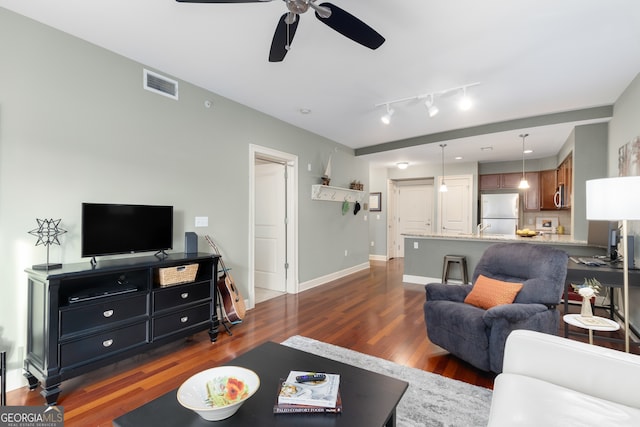 living room featuring dark wood-type flooring, sink, and ceiling fan