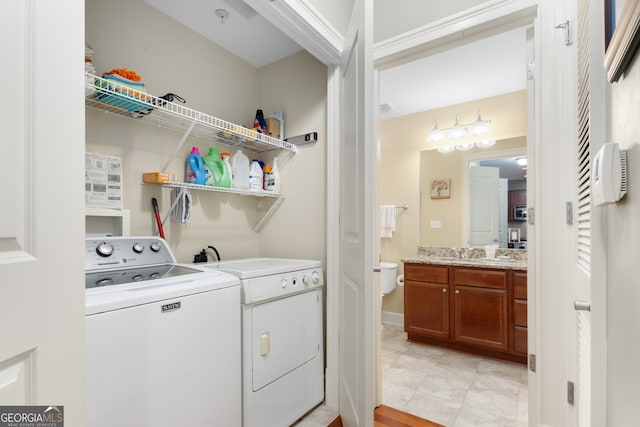 clothes washing area with sink and washing machine and dryer