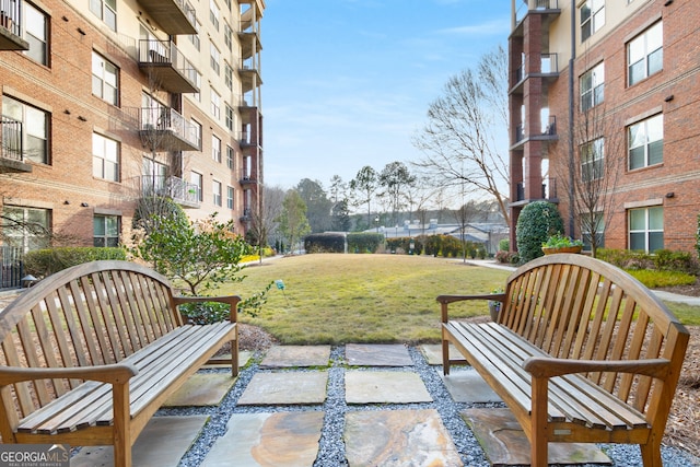 view of community featuring a yard and a patio area