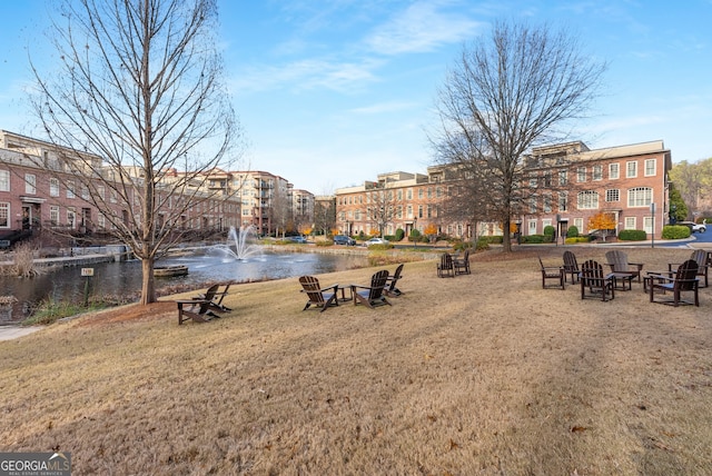 view of property's community featuring a water view and a lawn