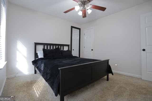 carpeted bedroom featuring ceiling fan and multiple windows