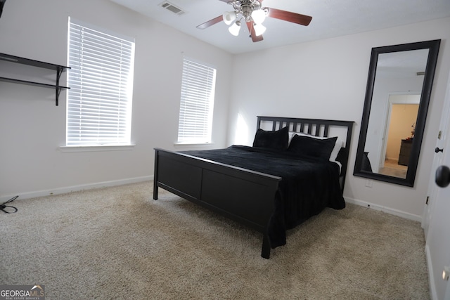 bedroom featuring light colored carpet and ceiling fan