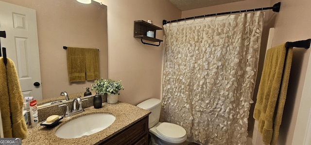 bathroom featuring toilet, vanity, and a shower with shower curtain