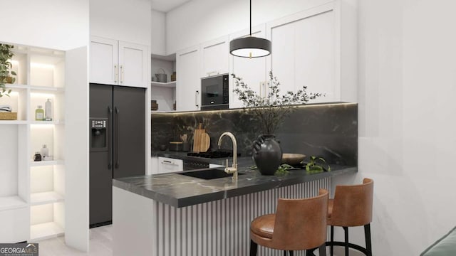 kitchen with black appliances, white cabinetry, sink, kitchen peninsula, and a breakfast bar