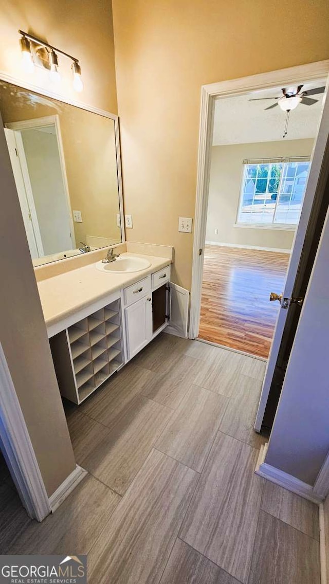 bathroom featuring ceiling fan and vanity