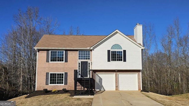 split foyer home featuring a garage and a front lawn