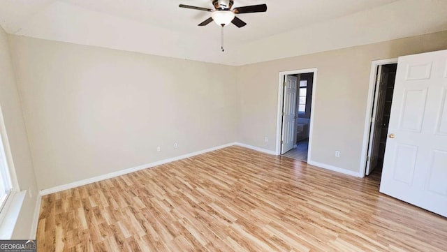 interior space with ceiling fan, ensuite bathroom, and light hardwood / wood-style flooring