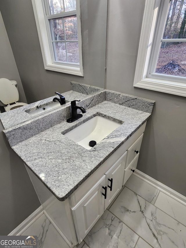 bathroom featuring vanity and toilet