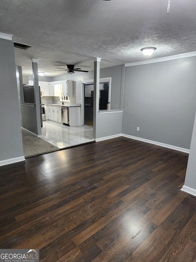 unfurnished living room with sink, hardwood / wood-style flooring, a textured ceiling, and ceiling fan