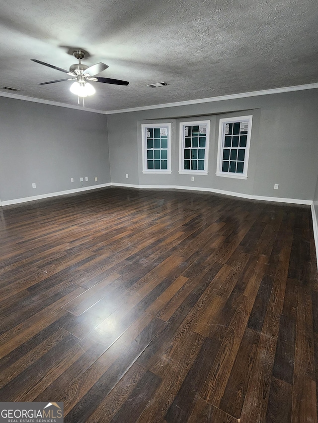 empty room with crown molding, ceiling fan, and dark hardwood / wood-style flooring