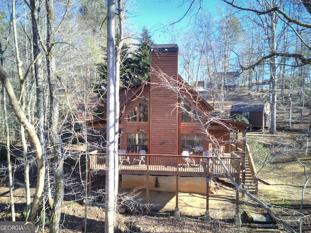 back of house featuring a deck