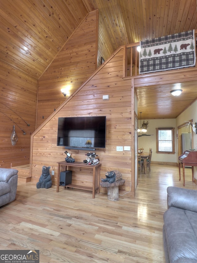 living room with hardwood / wood-style flooring, wooden ceiling, high vaulted ceiling, and wood walls