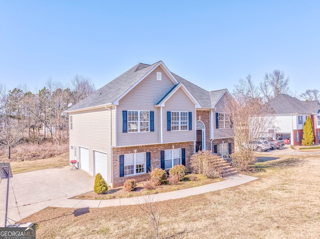 bi-level home featuring a garage and a front yard