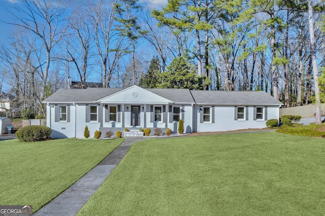 single story home with covered porch and a front yard