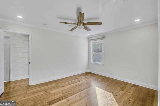 spare room featuring crown molding, ceiling fan, and light wood-type flooring