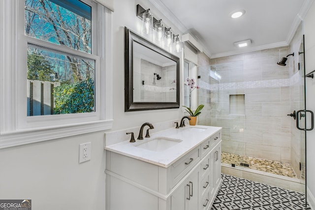 bathroom with ornamental molding, a shower with door, and vanity