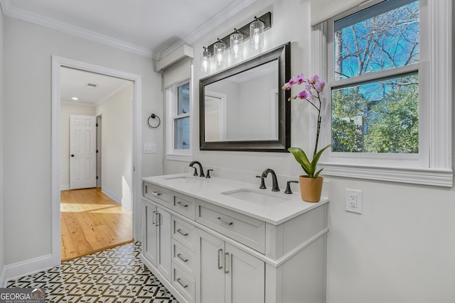 bathroom with ornamental molding and vanity