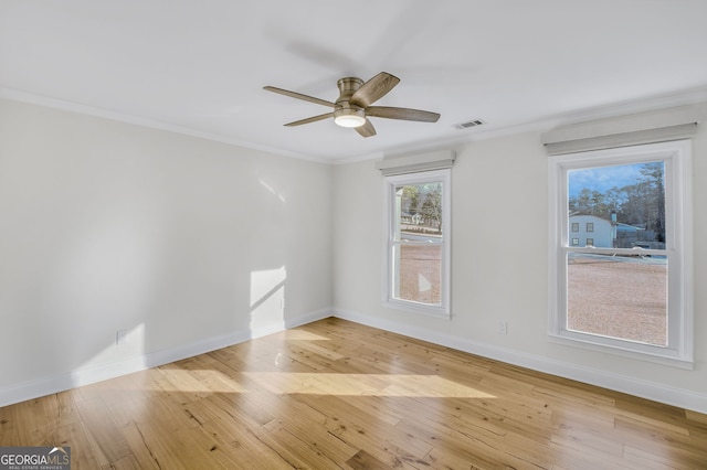 spare room with light hardwood / wood-style flooring, ornamental molding, and ceiling fan