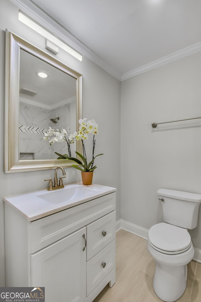 bathroom with vanity, ornamental molding, and toilet