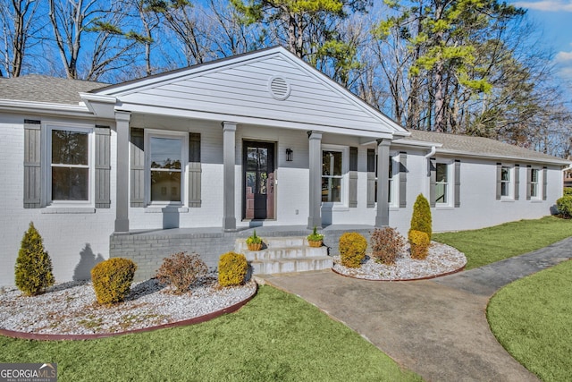 view of front of property with a porch and a front yard