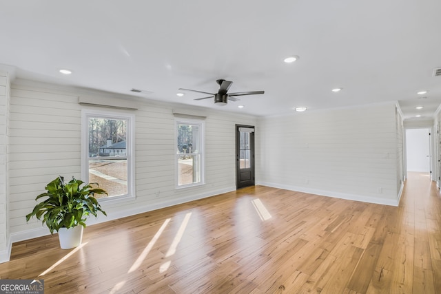 unfurnished room with ornamental molding, ceiling fan, and light hardwood / wood-style flooring