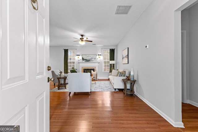 living room with hardwood / wood-style flooring and ceiling fan