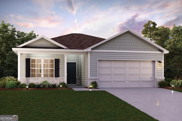 view of front of home with a garage and a lawn