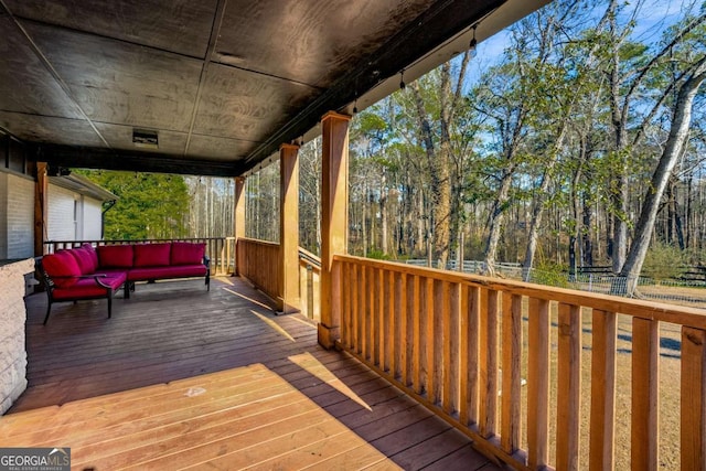 wooden deck featuring an outdoor living space