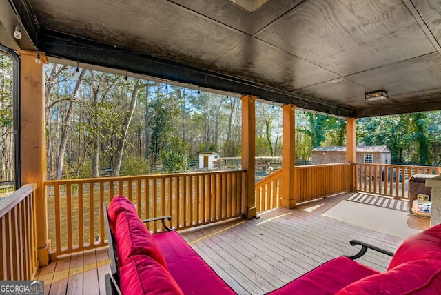 deck featuring outdoor lounge area and a storage shed