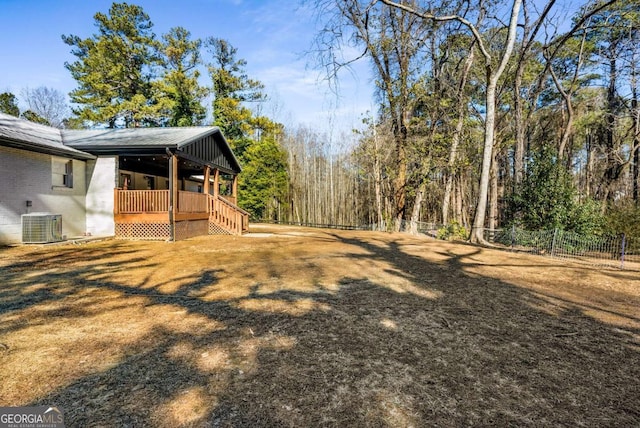 view of yard featuring covered porch and cooling unit