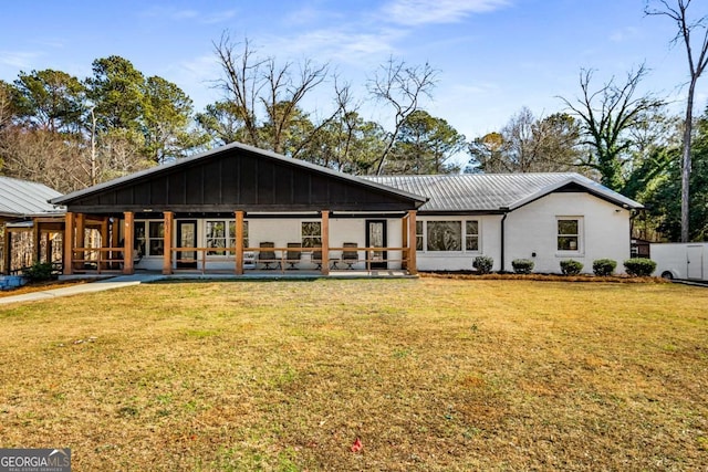 rear view of house with a lawn