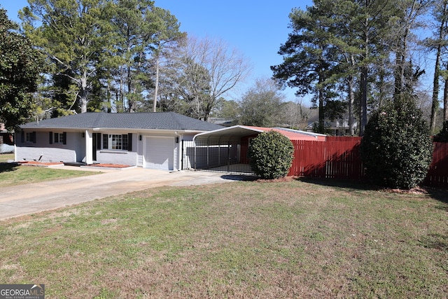 ranch-style house featuring a detached carport, concrete driveway, a front yard, fence, and a garage