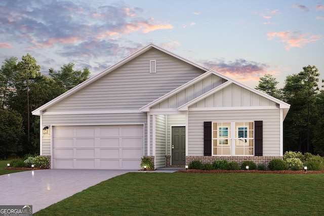 view of front of property featuring a garage and a lawn