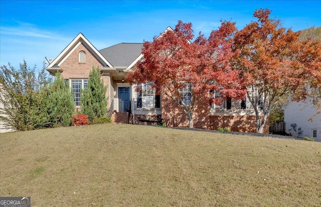 obstructed view of property with a front lawn