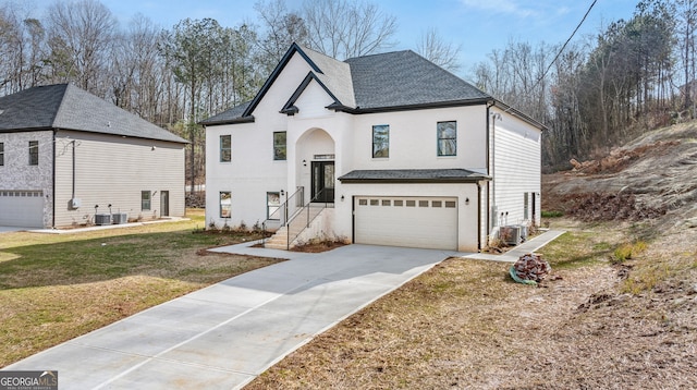 view of front of property featuring a garage, a front yard, and central AC unit