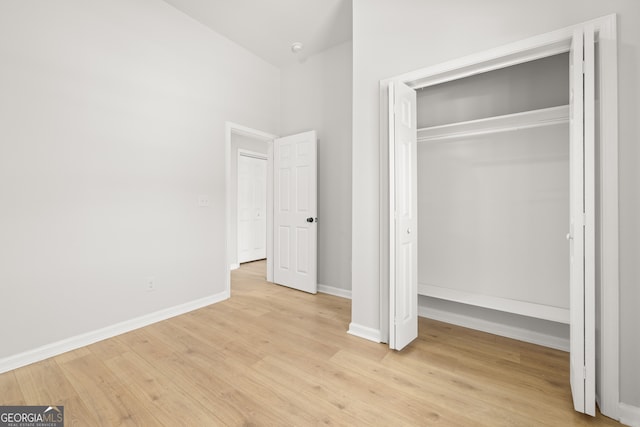 unfurnished bedroom featuring a closet and light hardwood / wood-style flooring