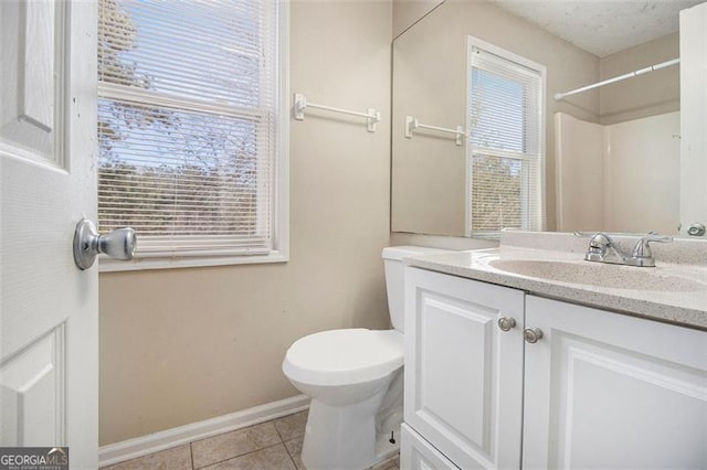 bathroom featuring vanity, toilet, walk in shower, and tile patterned flooring