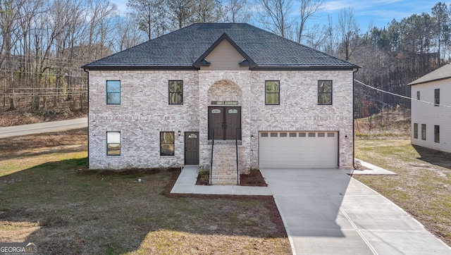 view of front of property with a garage and a front yard