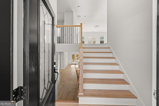 stairs with hardwood / wood-style floors