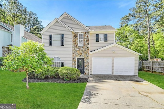 view of front of property featuring a garage and a front yard