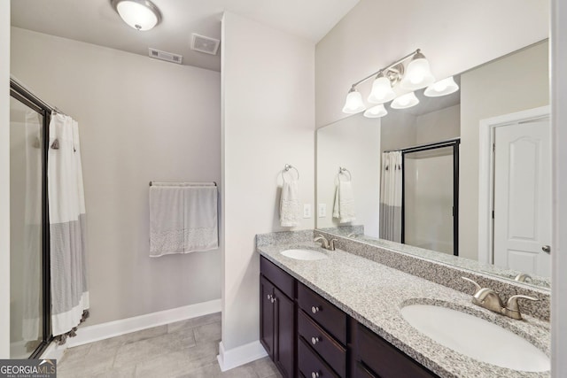 bathroom featuring tile patterned floors, walk in shower, and vanity