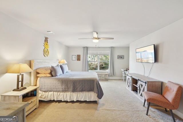 bedroom featuring ceiling fan and light carpet