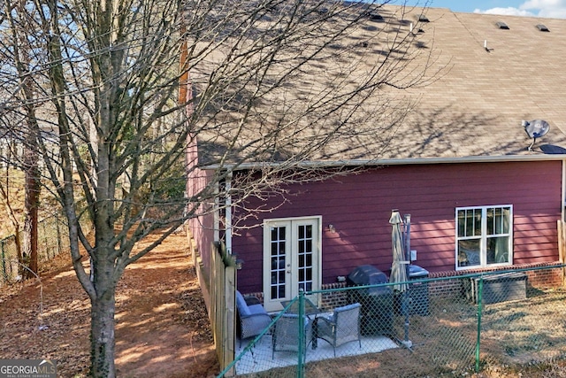 view of property exterior featuring french doors and a patio area