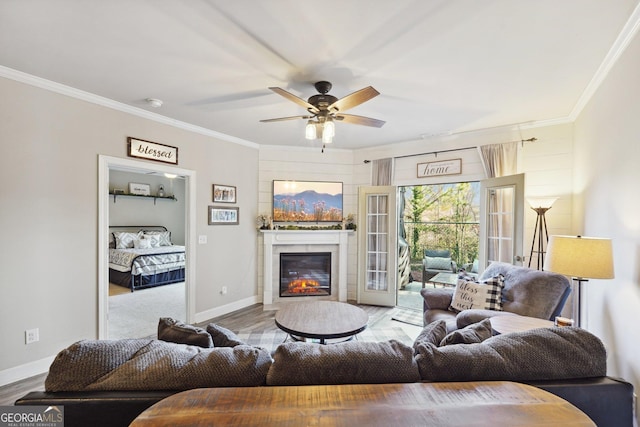 living room with ceiling fan, light hardwood / wood-style flooring, and crown molding