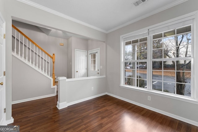 spare room with crown molding, dark wood-type flooring, stairway, and baseboards